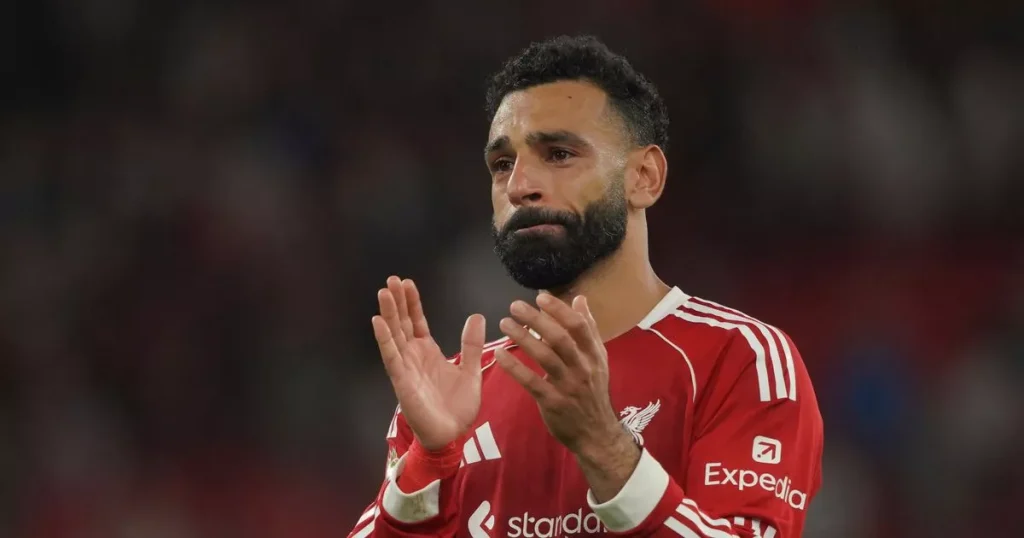 Mo Salah breaks in front of the cup as Diogo Jota salutes after Liverpool wins